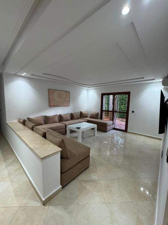 a living room with a couch and a table at Studio marina smir in Marina Smir
