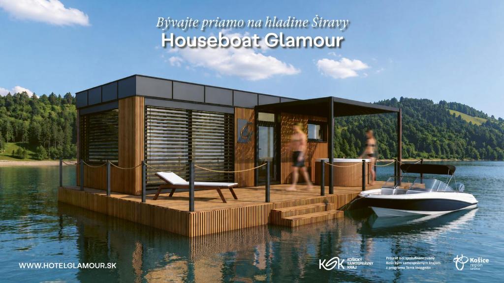 a house on a dock on the water with a boat at Houseboat Glamour & wellness in Kaluža