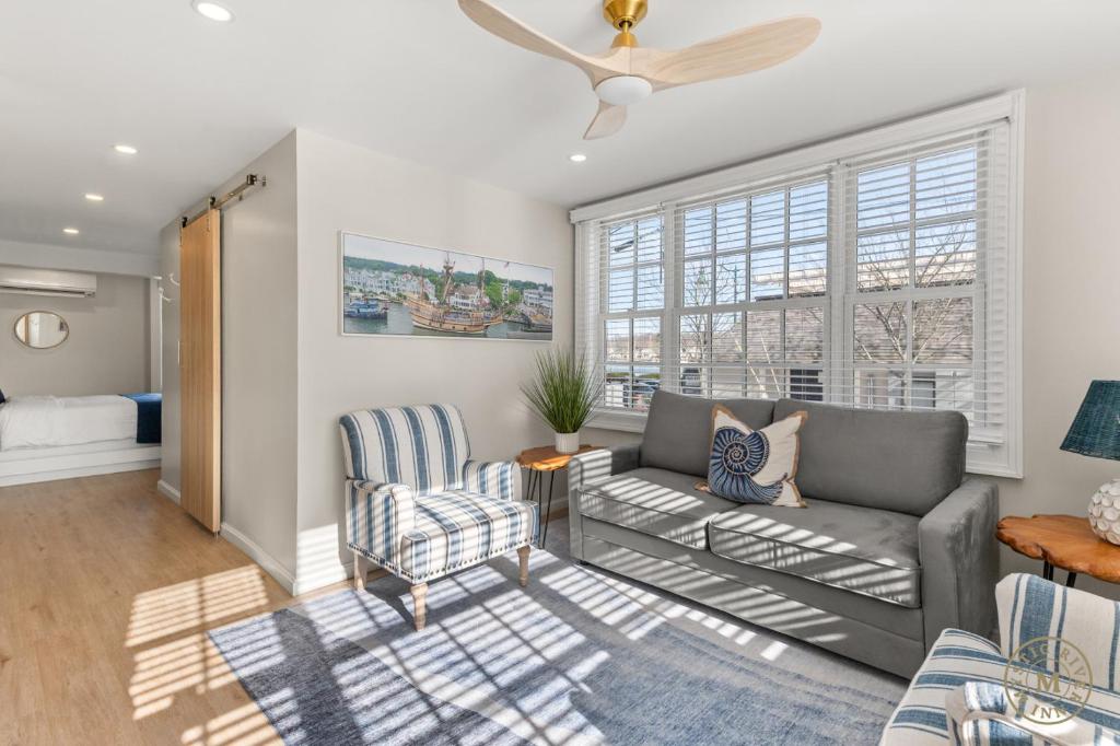 a living room with a couch and a chair at The Mystic River Inn - Downtown in Groton