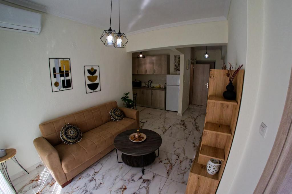 a living room with a couch and a table at Cloud9 Apartment in Kavála