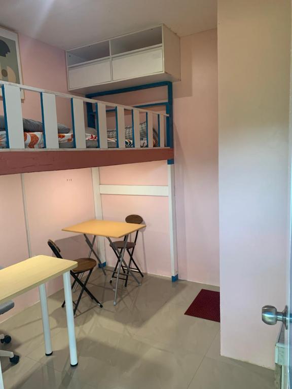 a room with two tables and a bunk bed at Kenjie Apartment in Cordova