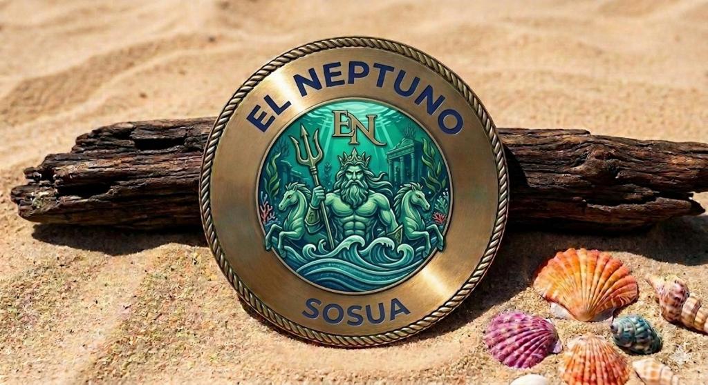a metal coin on the sand next to a beach at El Neptuno Residencial, Sosua in Sosúa