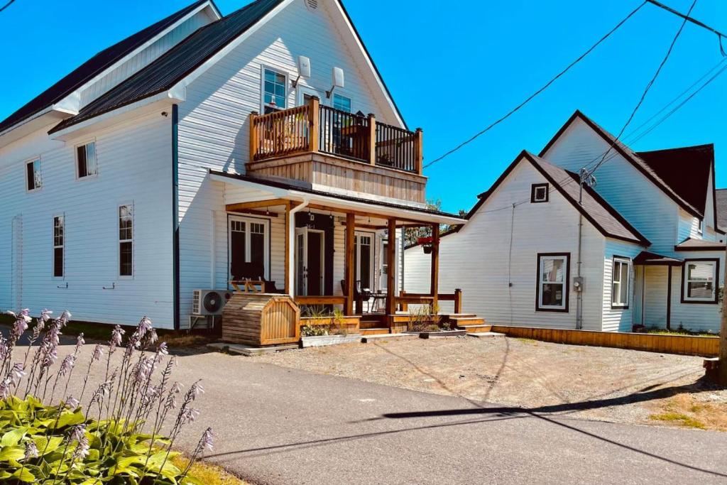 a large white house with a porch and a balcony at Alma 2 bedroom Sleeps 6 in Alma