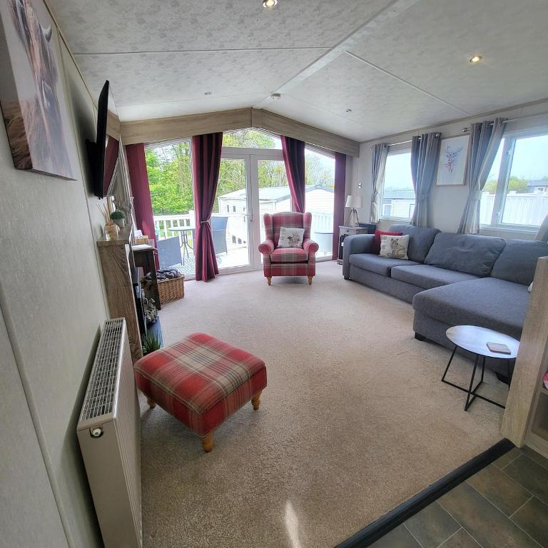 a living room with a blue couch and a chair at Bracken Lodge in Bucks Mills