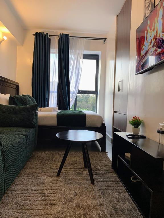 a living room with a couch and a table at Tsavo Rising in Nairobi