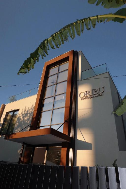 a building with a sign on the side of it at Oribu Boutique Hotel Vlore in Vlorë