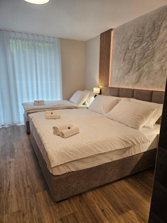 a bedroom with two beds with towels on them at Zasavski Gurman in Dol pri Hrastniku