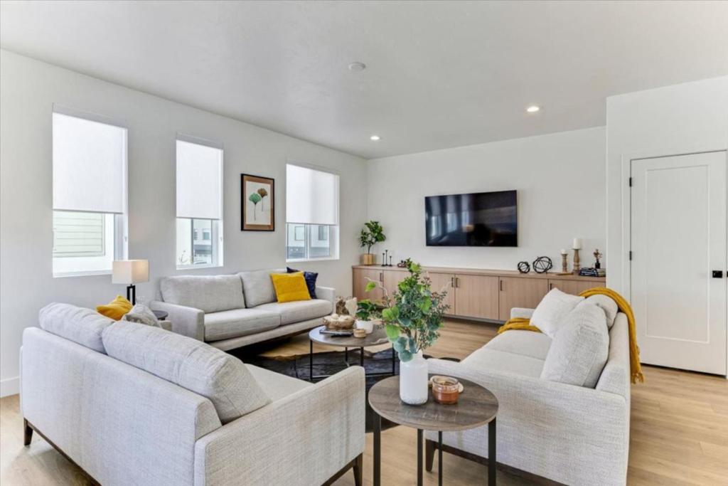 a living room with two couches and a table at Stylish Pet Friendly Home for Work & Relaxation in American Fork