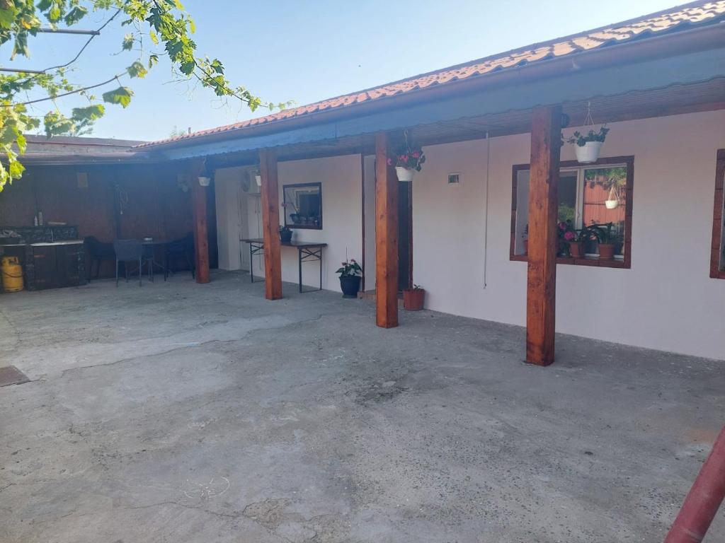 a house with a patio with a table and a table at Casa Micu in Corbu