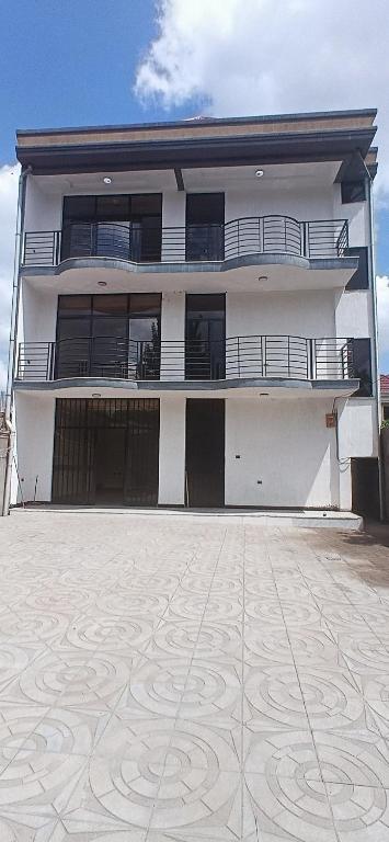 a white building with balconies and a courtyard at Bishoftu Bliss in Debre Zeyit