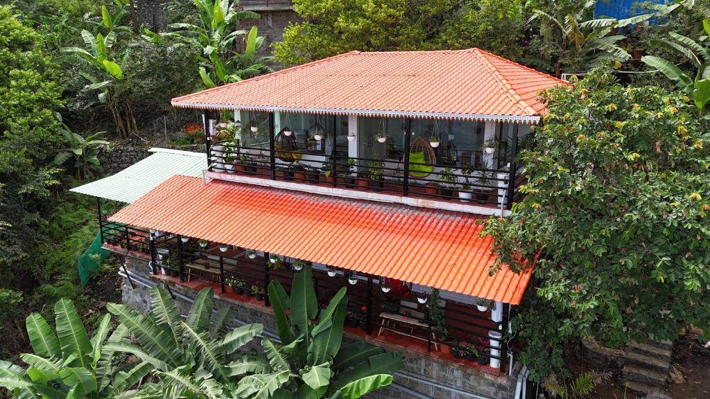 an overhead view of a building with an orange roof at KarSa Woods, Kodaikanal in Perumālmalai
