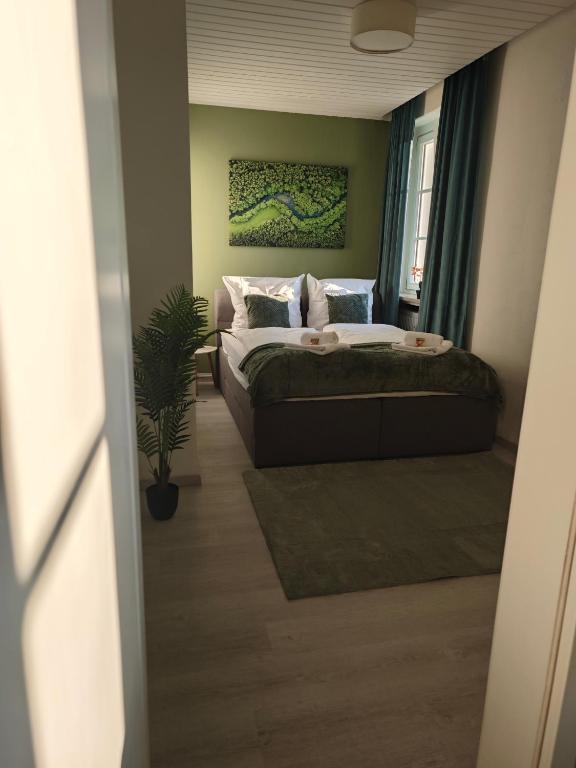 a bedroom with a bed and a potted plant at Monica Inn in Passau