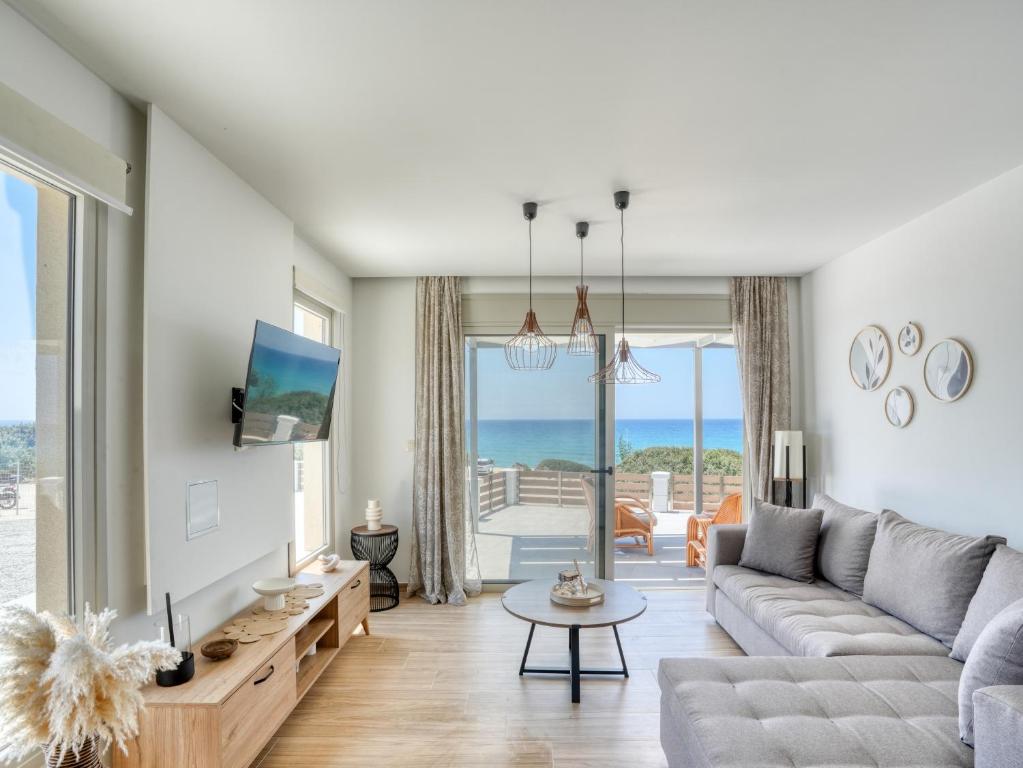 a living room with a couch and a table at Villa Elusia in Kefalos