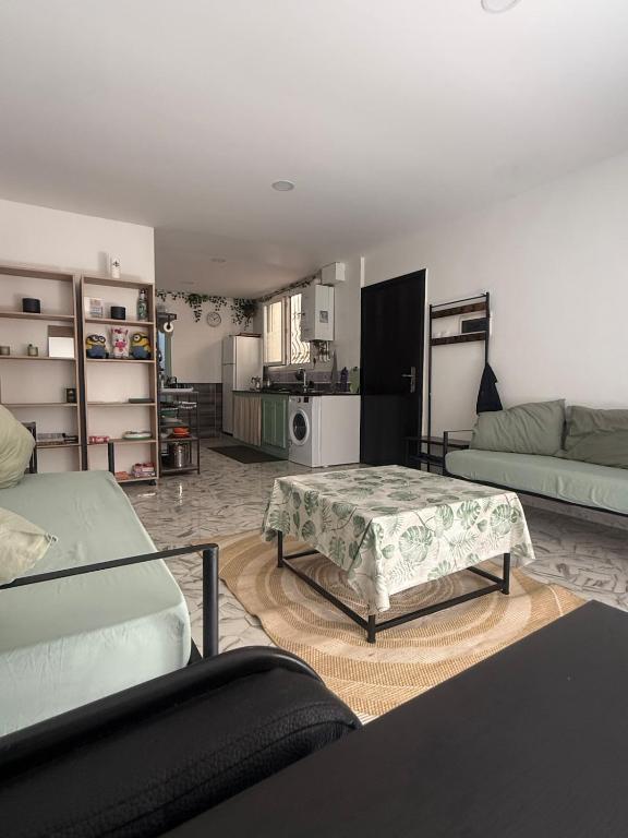 a living room with two beds and a couch at Mama house in El Marsa