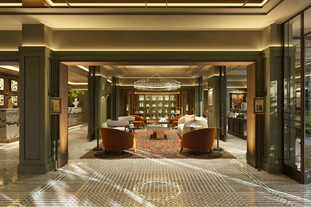 a lobby of a hotel with a chandelier at The St. Regis London in London
