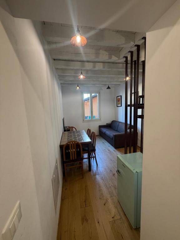 a living room with a table and a couch at Rovetta Tre Piazze Apartments in Brescia