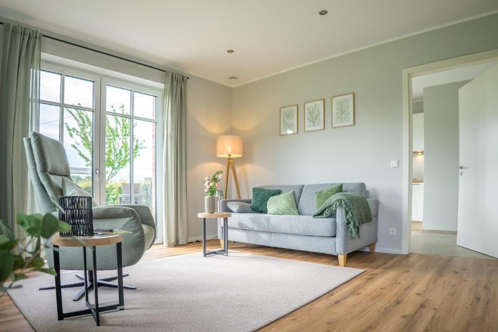 a living room with a couch and a chair at Ferienwohnung Landblick in Borken