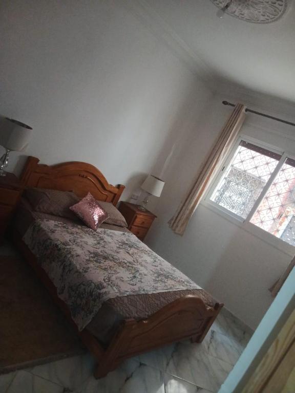 a bedroom with a bed and a window at Dardyafa in Larache