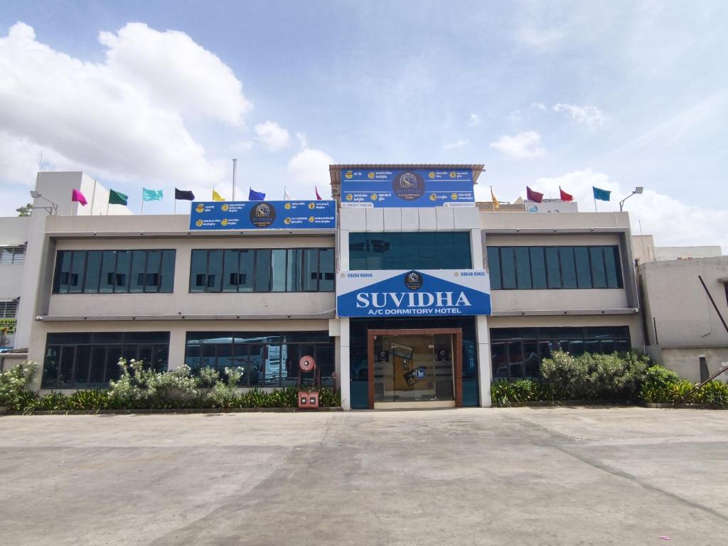 a building with a sign that reads swidenka at Suvidha Dormitory Hotel in Bhuj
