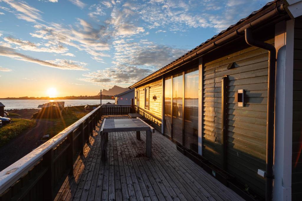 a balcony with a bench on the side of a building at Lofoten Green House in Ramberg