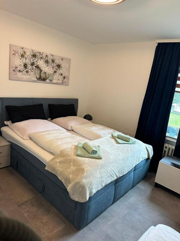 a bedroom with a bed with two towels on it at Kontinental C in Bad Harzburg