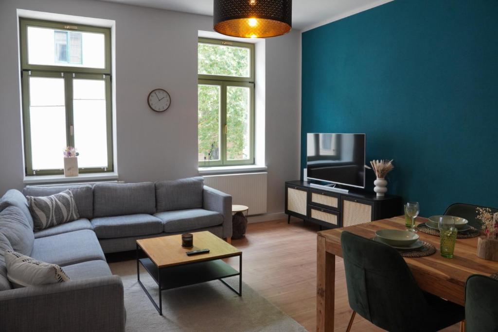 a living room with a couch and a table at Altstadtquartier Grimma in Grimma