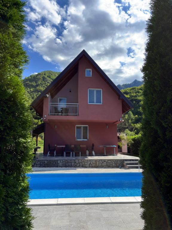 a house with a pool in front of it at Villa Pjene in Konjic