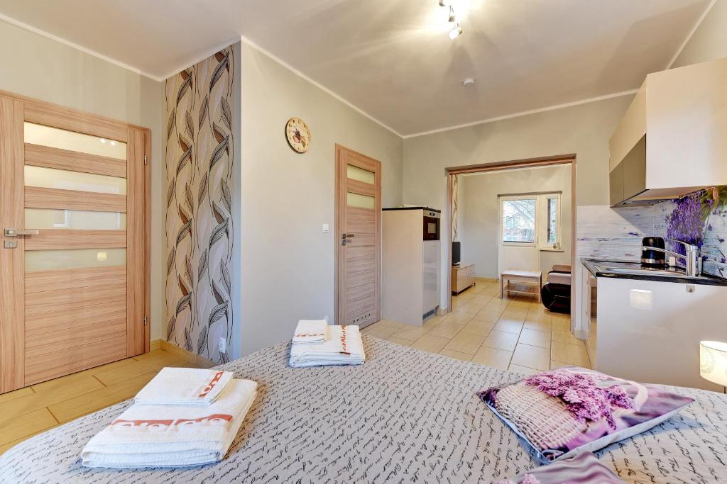 a bedroom with a bed with two towels on it at Villa Arkodes in Gdańsk