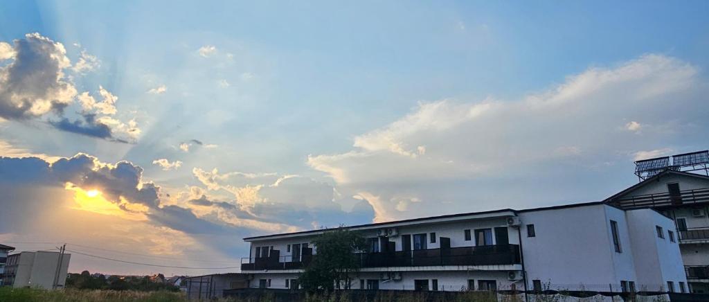 a building with a cloudy sky in the background at Casa Elizé in Schitul