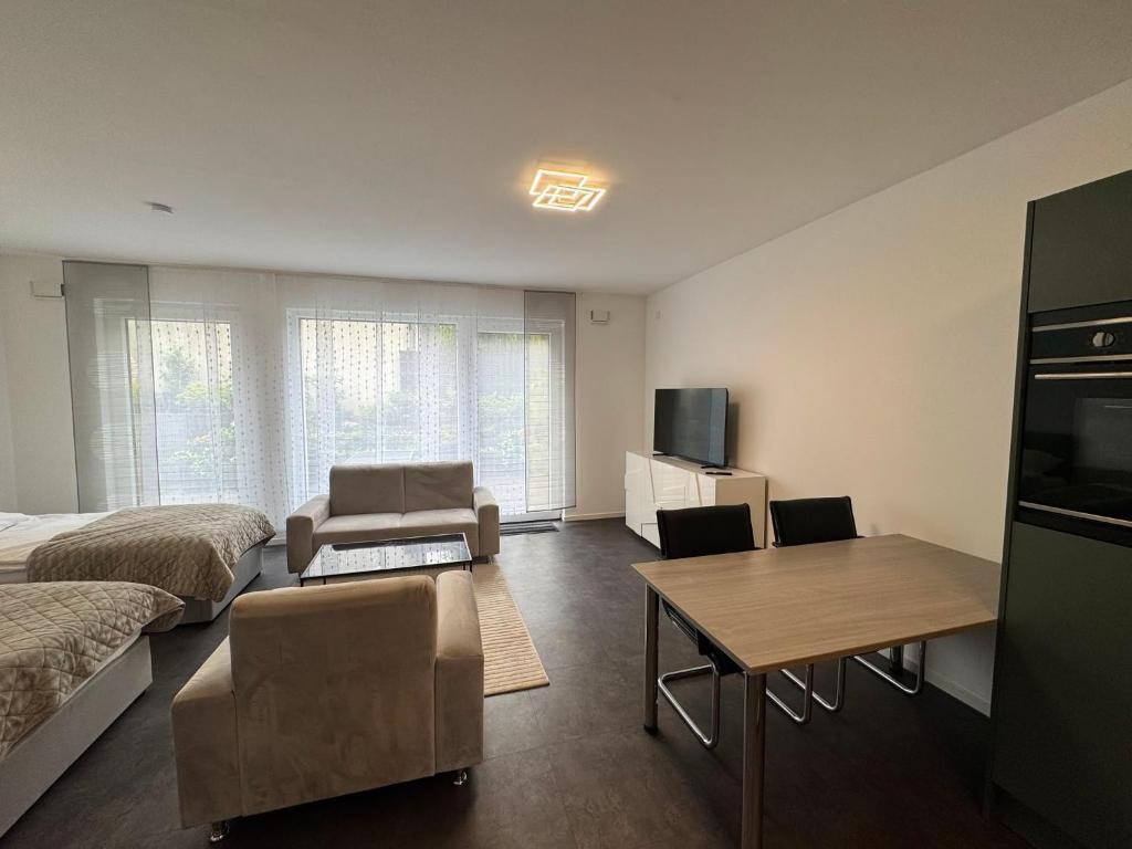 a bedroom with a bed and a table and a couch at Luxuriöse Apartment in Bochum