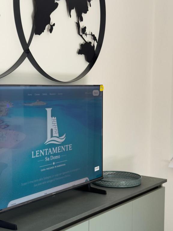 a computer monitor sitting on a desk with a mirror at Lentamente Domo in San Giovanni