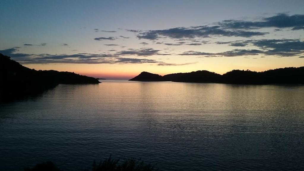 a sunset over a large body of water at Apartment Riva Lastovo in Ubli