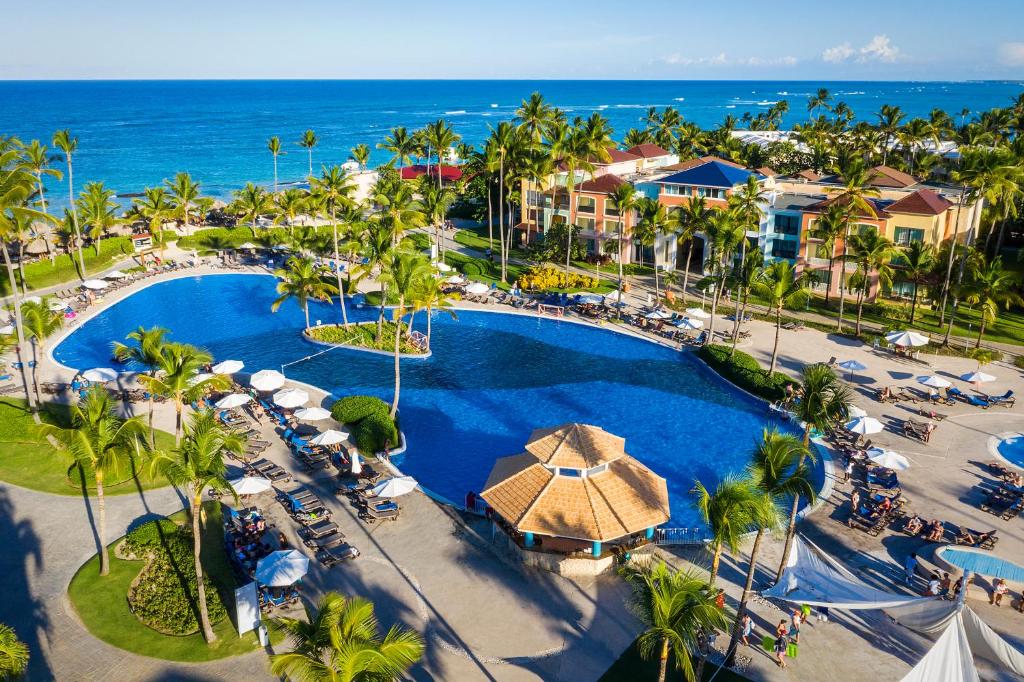 an aerial view of a resort with a pool and the ocean at Ocean Blue & Sand Beach Resort - All Inclusive in Punta Cana