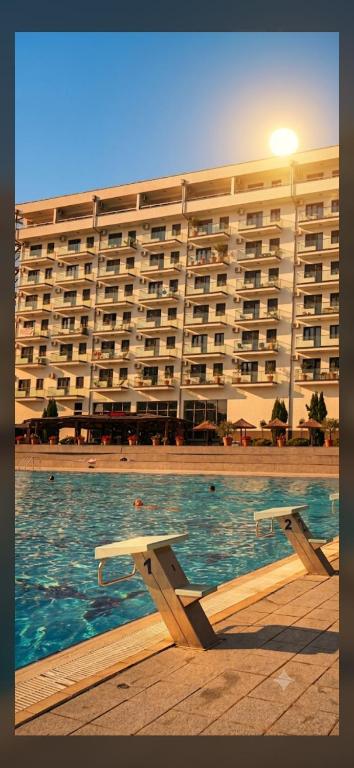a large building with a swimming pool in front of a building at Lena_Lux in Jagodina