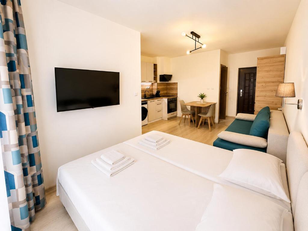 a bedroom with a bed and a living room at AM Sea Studios in Ravda