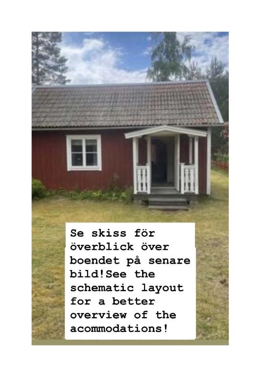 a sign in front of a red house at Stuga i Solvarbo, Dalarna in Gustafs