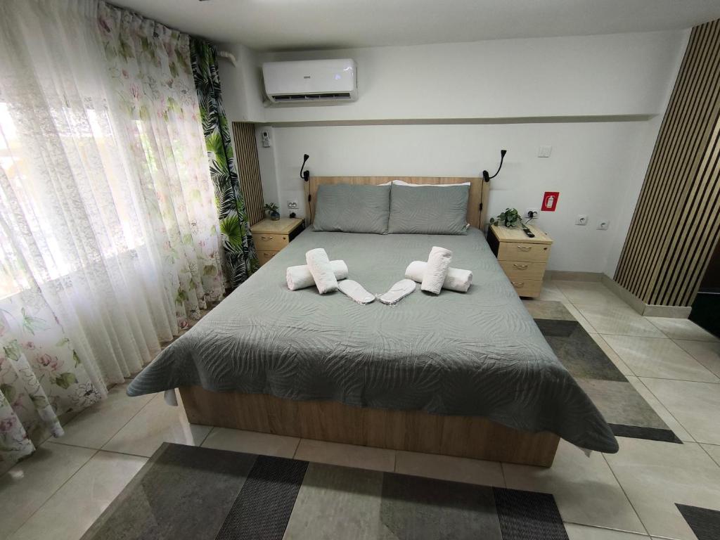 a bedroom with a bed with two towels on it at Emerald DesignHome near metro, tram, 10' Acropolis in Athens