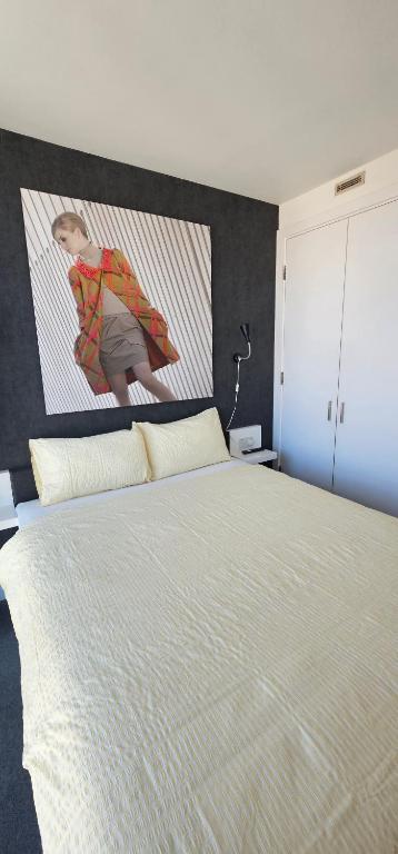 a bedroom with a large bed with a picture on the wall at Om calmness in Birmingham