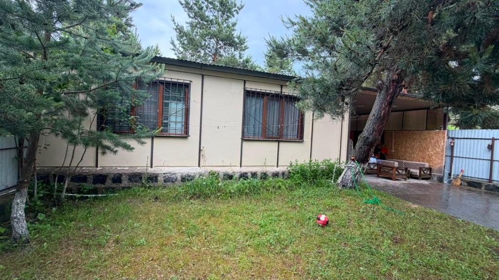 a house with a ball in the grass in front of it at Sweet Home 3 in Sevan
