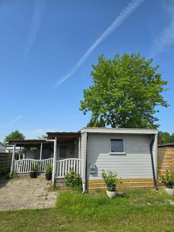 a house with a tree in front of it at Casa bosrust anloo in Anloo