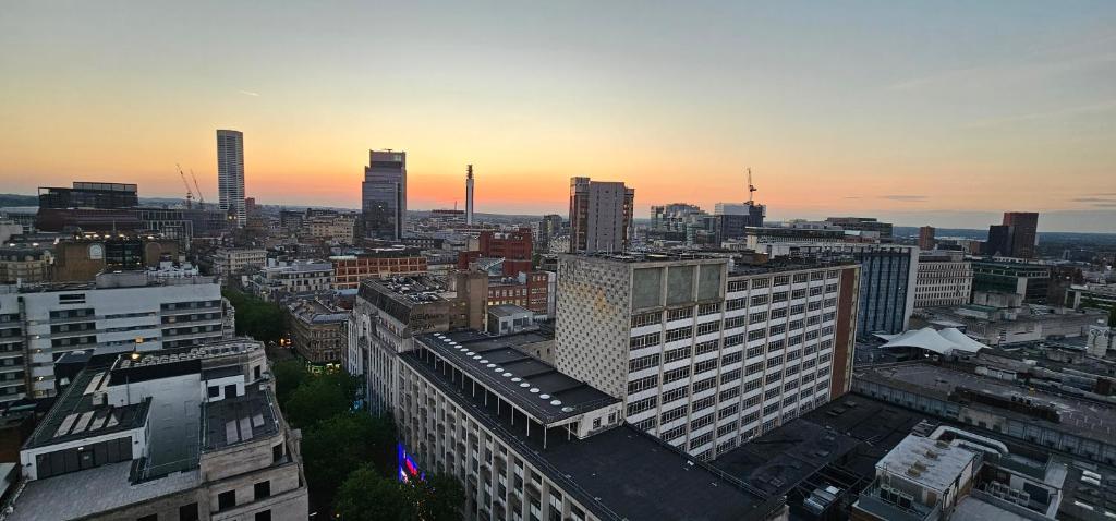 a view of a city at sunset with buildings at Namah peace in Birmingham