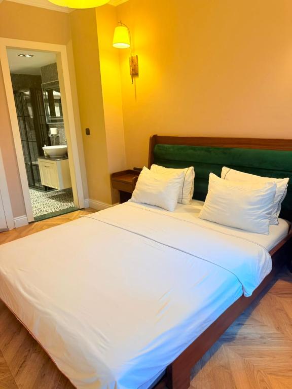 a large white bed with a green headboard in a room at D-orients in Istanbul