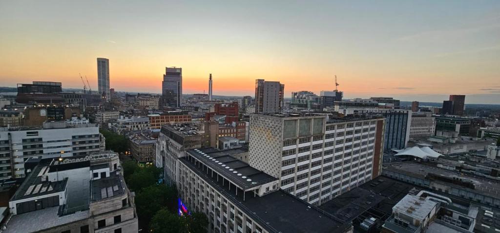 a view of a city at sunset with buildings at Shivay Harmony in Birmingham