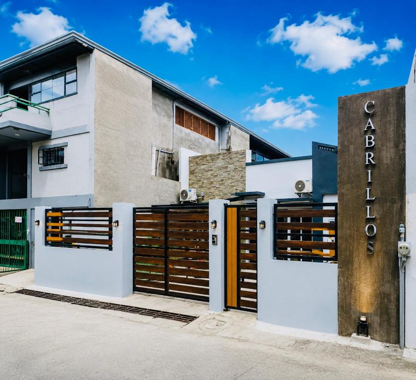a building with brown doors and a sign at Zenith Haven Casa de Padrillos in Imus