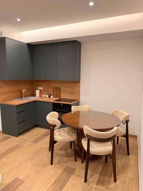 a kitchen with a wooden table and chairs at IK Apartments in Rake
