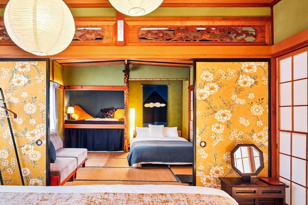 a bedroom with two bunk beds in a room at Nikko Botan - 3 Min Walk from JR Nikko Station in Nikko