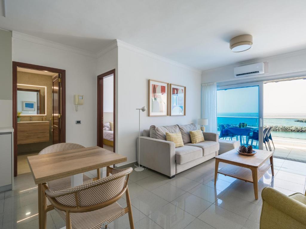a living room with a couch and a table at HolaMogamar in Puerto de Mogán
