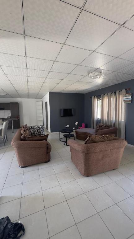 a living room with two couches and a table at River Gates Home in Rundu