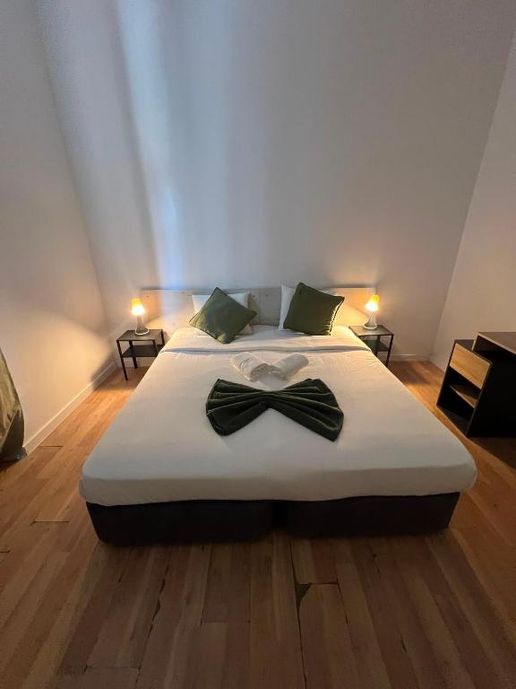 a bedroom with a bed with a bow tie on it at 7 Requinte HOSTel in Lisbon