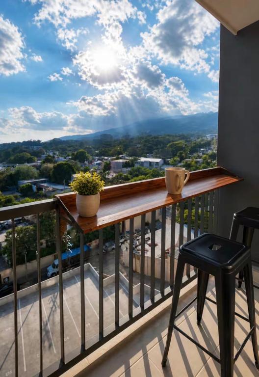 a balcony with a table and two chairs and a view at Apto de Paula in San Salvador